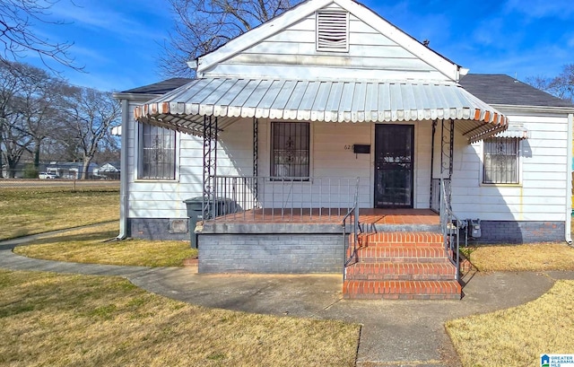 bungalow with a porch and a front yard