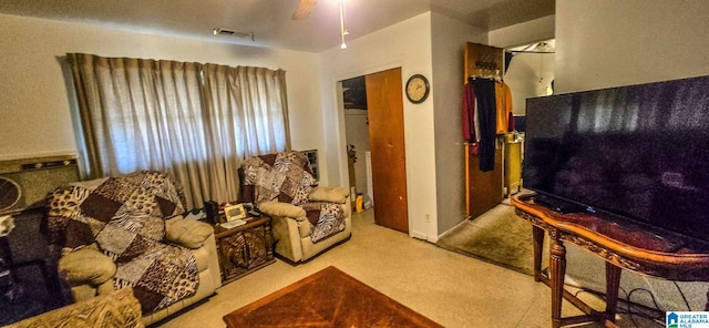 carpeted living room with ceiling fan