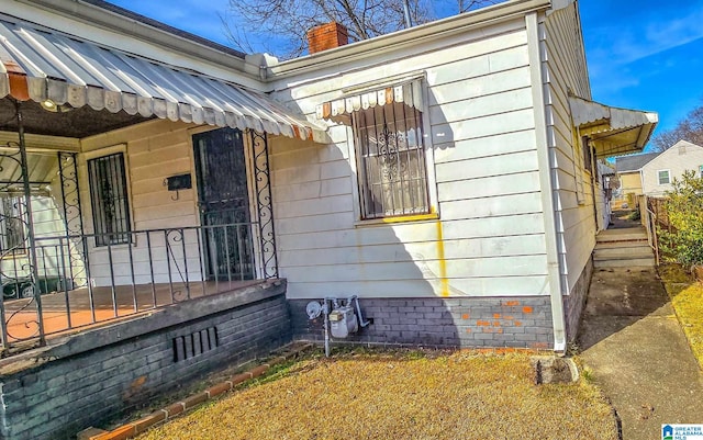 view of property exterior with covered porch