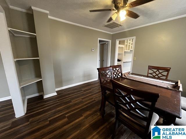 dining room featuring ceiling fan, ornamental molding, dark hardwood / wood-style floors, and a textured ceiling