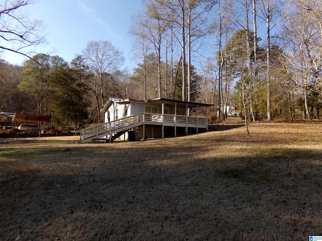 back of property with a lawn and a sunroom