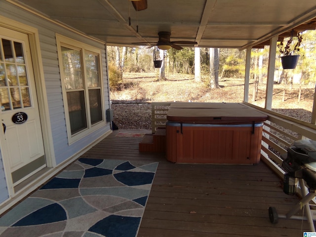 wooden deck with a hot tub