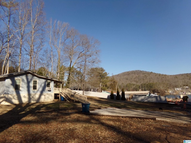 view of yard featuring stairway, fence, and a mountain view