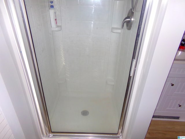 full bath with a shower stall