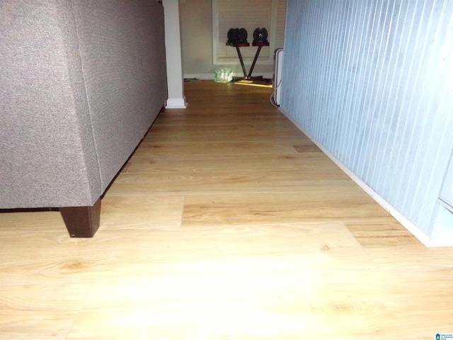 hallway with baseboards and wood finished floors