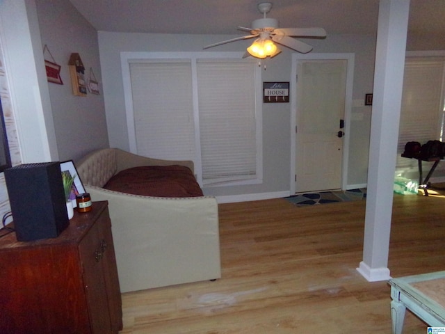 interior space with ceiling fan, light wood-style flooring, and baseboards