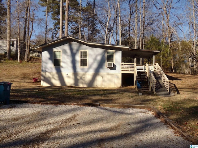 view of outbuilding featuring stairs and cooling unit