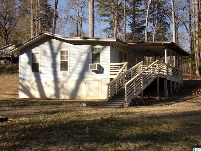 back of house featuring cooling unit, a yard, a deck, and stairs