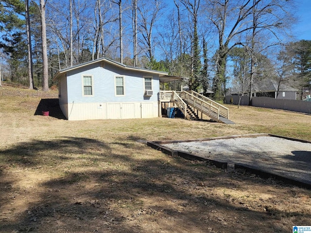 view of outdoor structure with fence and stairway