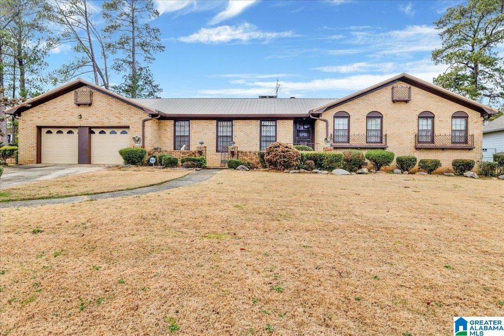 single story home featuring a garage and a front yard