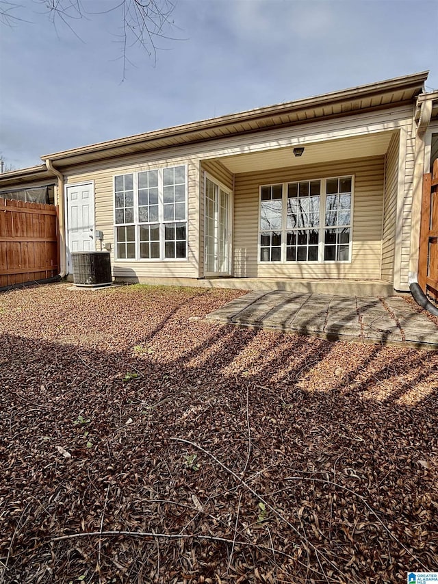 rear view of house featuring cooling unit and a patio