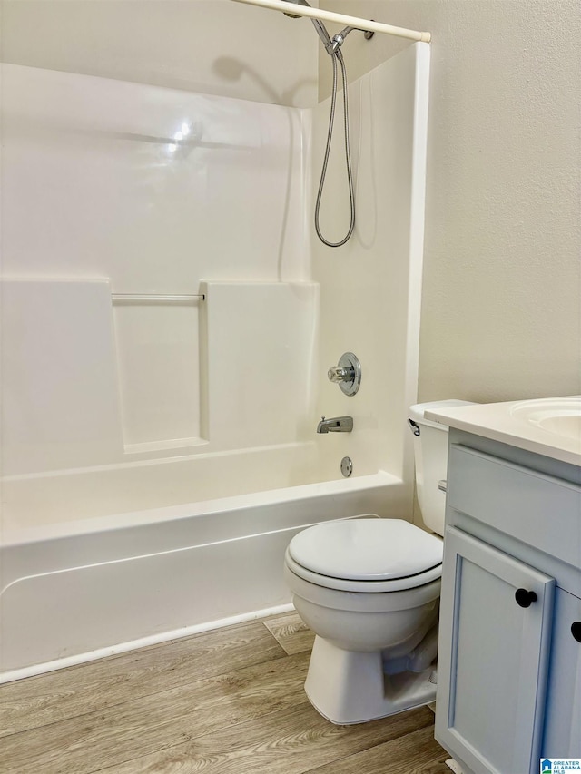 full bathroom featuring vanity, wood-type flooring, tub / shower combination, and toilet