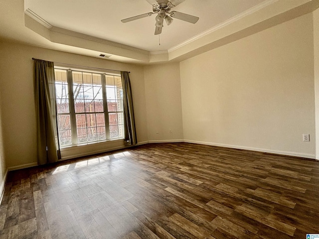 unfurnished room with crown molding, ceiling fan, dark hardwood / wood-style flooring, and a raised ceiling