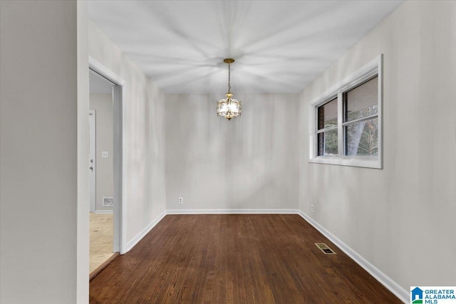 interior space with dark hardwood / wood-style flooring and a notable chandelier