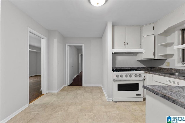 kitchen featuring white cabinetry, sink, and white range oven