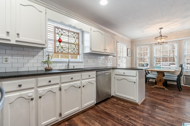 kitchen featuring white cabinetry, sink, decorative light fixtures, and stainless steel dishwasher