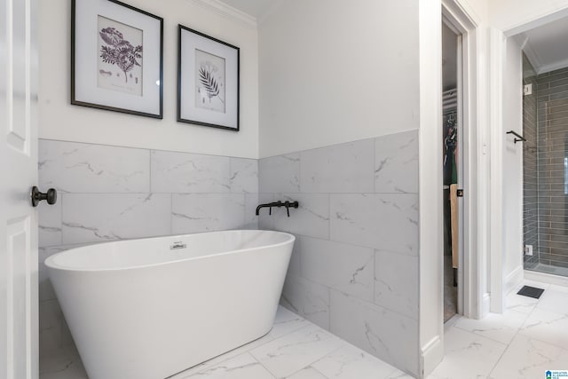 bathroom with ornamental molding, separate shower and tub, and tile walls