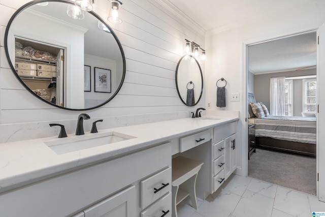 bathroom featuring crown molding, vanity, and wooden walls