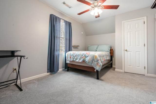 bedroom with ceiling fan, vaulted ceiling, and carpet