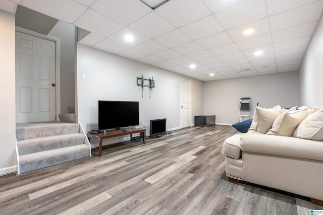 living room with hardwood / wood-style floors and a paneled ceiling