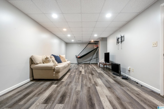 rec room with hardwood / wood-style floors and a drop ceiling