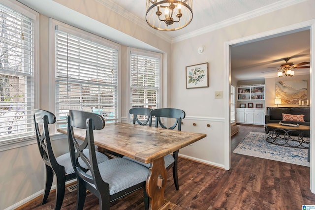 dining space featuring dark wood-type flooring, a textured ceiling, ornamental molding, built in features, and ceiling fan with notable chandelier