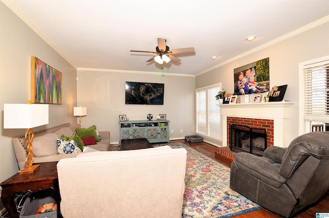 living room featuring crown molding, a healthy amount of sunlight, hardwood / wood-style floors, and a fireplace