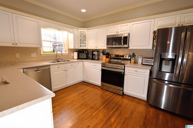 kitchen featuring white cabinetry, sink, crown molding, and appliances with stainless steel finishes