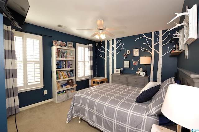 bedroom with multiple windows, light carpet, and ceiling fan