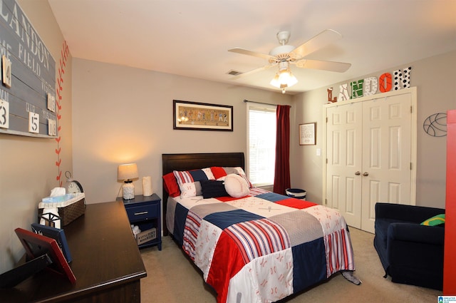 carpeted bedroom featuring ceiling fan and a closet