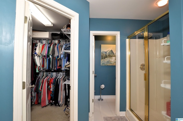 interior space with tile patterned flooring and walk in shower