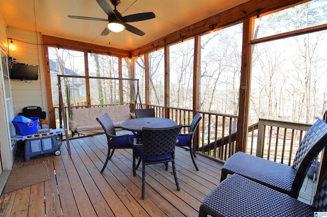 sunroom / solarium featuring ceiling fan