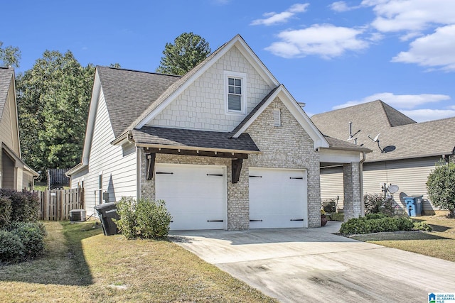 craftsman inspired home featuring a garage, central AC, and a front yard