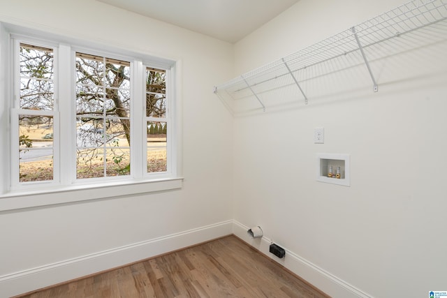 laundry room featuring washer hookup and hardwood / wood-style floors