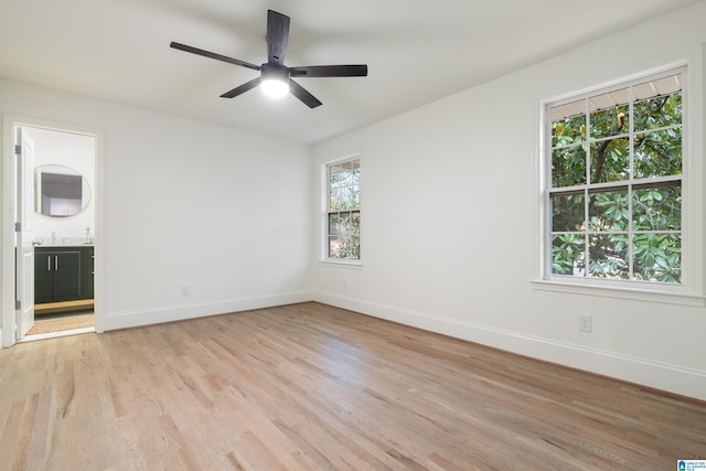 empty room with light hardwood / wood-style floors and ceiling fan