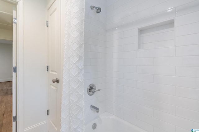 bathroom with shower / tub combo with curtain