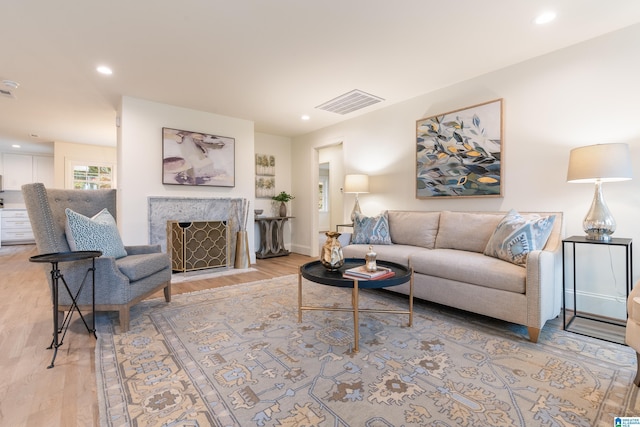 living room featuring a fireplace and light hardwood / wood-style floors