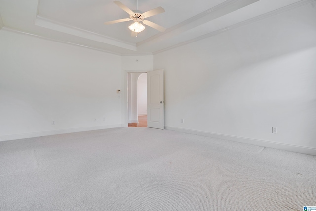 unfurnished room featuring carpet floors, ornamental molding, a raised ceiling, and ceiling fan