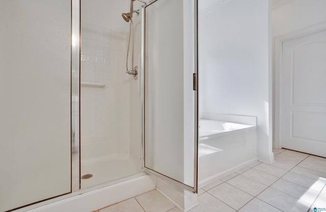 bathroom with tile patterned flooring and separate shower and tub