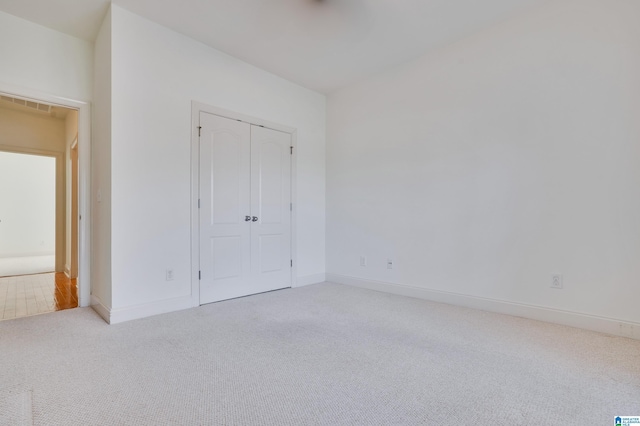 unfurnished bedroom with light colored carpet