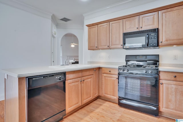 kitchen featuring sink, crown molding, light wood-type flooring, kitchen peninsula, and black appliances