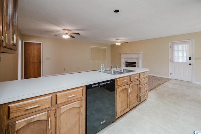 kitchen featuring ceiling fan, a fireplace, dishwasher, and sink