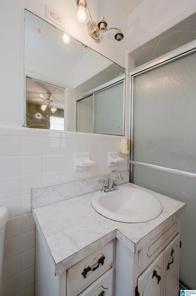 bathroom with vanity, tile walls, backsplash, and walk in shower