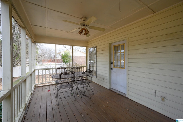 unfurnished sunroom with ceiling fan