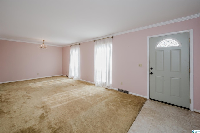 carpeted entrance foyer featuring crown molding and a chandelier