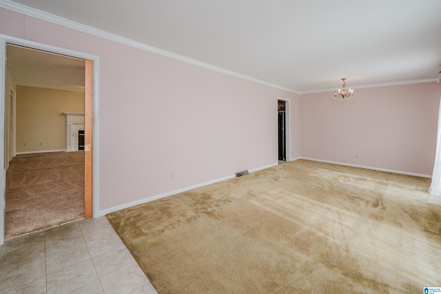 carpeted empty room with an inviting chandelier and crown molding