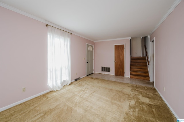 unfurnished room with crown molding and light colored carpet