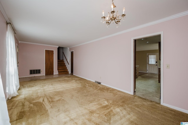 carpeted spare room with crown molding and a chandelier