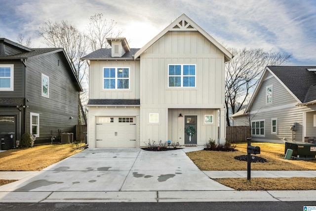 view of front of house featuring a garage and cooling unit