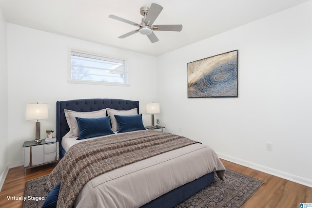 bedroom with dark hardwood / wood-style floors and ceiling fan